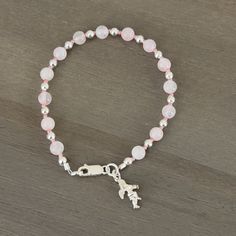 💜Pink rose quartz beads alternate with small hot pink seed beads and sterling silver spacer beads. 💜Sterling silver lobster claw clasp. 💜Small sterling  silver angel charm. 💜Pink and silver in color. 💜8 in/20.32 cm in length. 💜Rose Quartz is connected to the upper 4 chakras. Promotes compassion, forgiveness, and calm. Helps clear stored anger and resentment. 💜Link below to view all bracelets in my shop. https://www.etsy.com/shop/HisHandsJewerly?section_id=35856291 💜This bracelet comes with a purple velvet protective pouch. Adjustable Pink Beaded Bracelet With Silver Beads, Adjustable Pink Charm Bracelet With Spacer Beads, Pink Beaded Rosary Bracelet With Round Beads, Sterling Silver Beaded Charm Bracelet With Round Beads, Pink Sterling Silver Crystal Bracelet As A Gift, Sterling Silver Crystal Bracelet With Round Beads, Pink Beaded Rosary Bracelet, Spiritual Pink Charm Bracelet With Round Beads, Adjustable Silver Rosary Bracelet With Gemstone Beads