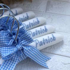 four blue and white napkins tied together with a bow on the top, sitting in front of a basket