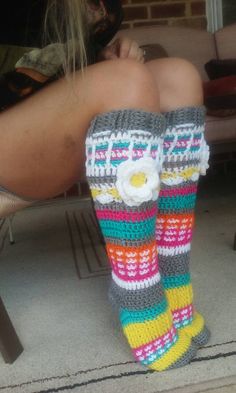 a woman's legs wearing colorful socks with flowers on them and the words crochet designs written in white