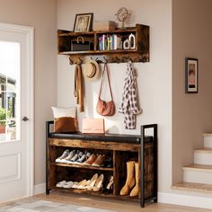 there is a shelf with shoes and purses on it next to the stairs in this entryway