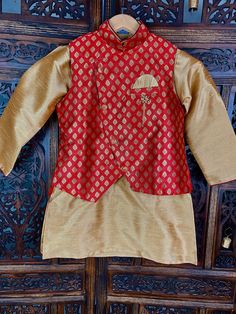 Boys 3pcs Set Kurta Pajama Set in Raw Silk Material in Gold. The Jacket is Banarasi Soft Silk with Buttis. Bottom is Balloon Style. Item : Boys Kurta Pajama Ready to Wear : Yes Kurta Color : Orange with Light Gold Jacket with floral Pattern Pajama Color : Light Gold Fabric : Raw Silk and Banarasi Soft Silk Pocket : Yes Lining : No Disclaimer - There can be little variation in the color due to screen resolution setting, phone display setting or anything else. Kindly do not hold us responsible. Designer Long Sleeve Sets For Diwali, Festival Zari Work Straight Kurta Outerwear, Gold Nehru Jacket With Dupatta For Eid, Festive Transitional Chanderi Sets, Traditional Gold Sets For Diwali, Gold Sets With Traditional Patterns For Diwali, Gold Bollywood Sets With Traditional Patterns, Gold Sets With Traditional Patterns For Eid, Fitted Straight Kurta Sets For Puja