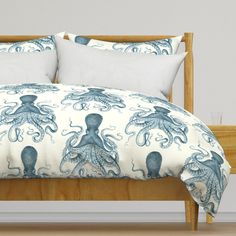 a bed with an octopus comforter and pillows