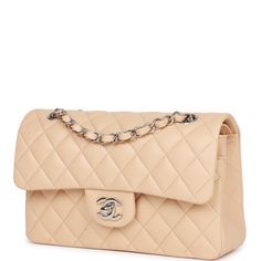 This Small Classic Double Flap bag is in beige clair lambskin leather with silver tone hardware and features a front flap with signature CC turnlock closure, half moon back pocket, and adjustable interwoven silver tone chain link and beige leather shoulder strap.The interior is lined in beige leather with the "love letter" zipper compartment underneath the first flap, an "outer" slit pocket under the second flap, and an interior compartment with two open pockets separated by a "lipstick" compartment.Collection: 22SOrigin: FranceCondition: New and never wornAccompanied by: Chanel box, Chanel dustbag, carebook, ribbon and retail UPCMeasurements: 9" width x 5.25" height x 2.5" depth; 16.5" strap drop (9.5" doubled) Chanel Classic Flap Bag Medium, Saree Types, 2023 Handbags, Office Bags For Women, Office Handbags, Mk Handbags Michael Kors, Types Of Handbags, Chanel Beige, Statement Handbag