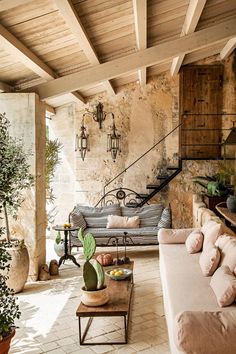 a living room filled with furniture and lots of plants