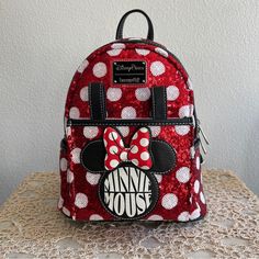 Disney Loungefly Minnie Mouse Polka Dot Sequin Mini Backpack - Nwt Cloisonne Disney Parks X Loungefly Label At Front All-Over Sequin Embellishments And Polka Dot Pattern Double Zip Fastening Exterior Pocket Ideal For Carrying Ears Headbands Appliqu Minnie Icon With 'Minnie Mouse' Wording On Pocket Contrast Stitching 2 Small Side Pockets Top Carry Handle Adjustable Shoulder Straps Padded Back Created By Loungefly Part Of The Disney Parks X Loungefly Collection Approximete Measurements: H26.5 X W2 Disney Minnie Mouse Backpack For Travel, Disney Style Backpack With Zipper Closure, Trendy Minnie Mouse Travel Backpack, Minnie Mouse Backpack For Travel, Trendy Minnie Mouse Backpack For Travel, Minnie Mouse Standard Backpack For Travel, Minnie Mouse Travel Backpack, Red Disney Minnie Mouse Backpack, Disney Red Minnie Mouse Backpack