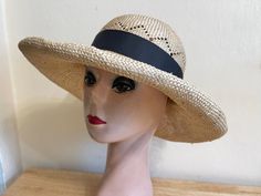 This hand-blocked natural  sisal straw sun hat has a 4-inch brim and will fit up to 22 7/8-inch head size. Around the crown is a diamond pattern and the brim is solid. There is a removable black grosgrain ribbon band that can be used to adjust the head size to fit your head. The brim has a one-inch roll edge. I have other colors of ribbon, please convo me with any requests.  NOTE: Please check the head size before purchase, I am happy to answer any questions you may have. There will be a 20% restocking fee for all returned hats. Straw Sun Hat, Wide Brim Sun Hat, Natural Sisal, Vintage Band, One Inch, Black Ribbon, Sun Hat, Wide Brimmed, Diamond Pattern