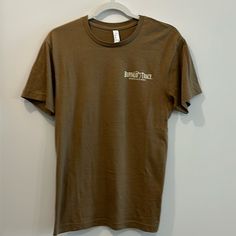 Never Worn An Imperfect Condition. Measurements Length 26 Inches Armpit To Armpit 18 Inches. Fitted Crew Neck T-shirt In Khaki, Brown Crew Neck Top, Brown Relaxed Fit Graphic Tee Shirt, Brown Relaxed Fit Graphic Tee, Brown Basic Short Sleeve Shirt, Basic Brown Short Sleeve Shirt, Brown Relaxed Fit Pre-shrunk T-shirt, Fitted Brown Graphic T-shirt, Fitted Brown Graphic Tee