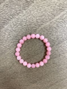 This elegant bracelet is the perfect accessory for adding a subtle pop of color to any outfit! Featuring 8mm peony pink jade beads, this bracelet is guaranteed to make a statement without overpowering your look. 💖 Bracelets made 7 inches unless buyer lets us know to make them smaller or larger. Please refer to our sizing page. HOC-Summer Pink Rose Quartz Round Stretch Bracelet, Elegant Rose Quartz Stretch Bracelet With Round Beads, Pink Rose Quartz Stretch Bracelet, Pink Stretch Bracelet With Gemstone Beads, Pink Rose Quartz Stretch Bracelet With 8mm Beads, Elegant Pink Bracelets With 8mm Beads, Hoc Summer, Pink Jade, Peony Pink