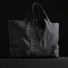 The perfect travel tote bag with an inside pocket and comfortable shoulder straps. This bag is constructed from thick, durable canvas that is ideal for travel, beach and overnight use.Additional Information:• 40% Cotton, 40% Linen, 20% Polyurethane. • Imported• Width: 29 in. Height: 21 in. • Inside Pocket Width: 12 in. Height: 11 in. • Shoulder Strap Drop: 7 1/2 in. • Spot clean. Black Cotton Beach Bag For Travel, Black Cotton Travel Beach Bag, Black Weekender Bag With Canvas Lining For Daily Use, Black Cotton Weekender Bag With Large Capacity, Black Travel Bag With Canvas Lining For Daily Use, Black Cotton Weekender Bag For Everyday Use, Travel Tote Bag, Travel Beach, Small Canvas