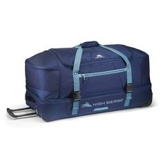 a large blue duffle bag sitting on top of a white floor