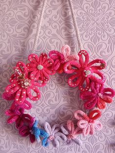 a crocheted wreath hanging on a wall