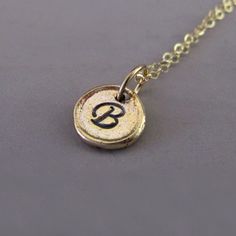 Tiny 14k Yellow Gold Initial Necklace  Pebble by esdesigns on Etsy Minimalist Personalized Charm Necklaces In Recycled Gold, Minimalist Personalized Charm Necklace In Recycled Gold, Minimalist Personalized Jewelry For Meditation, 14k Gold Hand Stamped Charm Necklaces With Round Pendant, Hand Stamped 14k Gold Round Pendant Charm Necklaces, Hand Stamped 14k Gold Charm Necklace With Round Pendant, Stamped Gold Charm Necklaces In Sterling Silver, Gold Stamped Sterling Silver Charm Necklaces, Gold Sterling Silver Stamped Charm Necklaces