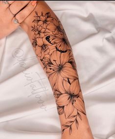 a woman's arm with flowers on it