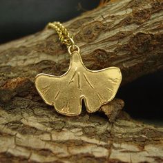 "Hand sculpted ginkgo biloba necklace. Ginkgo biloba is a very old species, with some fossils dating back 270 million years. Native to China, the tree is widely cultivated, and was cultivated early in human history. It has various uses in traditional medicine and as a source of food. In Japanese decorative art, the ginkgo's distinctive fan-shaped leaf has carried symbolism along with its singular beauty: the ginkgo has been a symbol of longevity (the tree can live for a thousand years) and of a Food In Japanese, Hermes Necklace, Art Nouveau Necklaces, Ginkgo Tree, Gingko Leaves, Tarpon Springs, Arrowhead Necklace, Ginkgo Biloba, Ginkgo Leaf