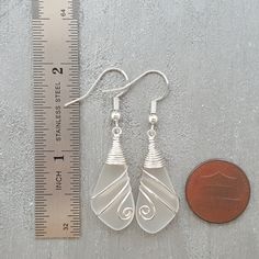 "Aloha! These design shows my love for this beautiful island of Hawaii. This item will be made to order and shipped directly from Hawaii. This is sea glass earrings with silver hooks. This handmade in Hawaii jewelry gift is from cultured sea glass that are specially formed into its shape for jewelry making. Each comes with a gift box with \"handmade by yinahawaii\" stamp and a ribbon wrapped as shown in the 2nd photo, ready to give as gift. I also offer Free gift messaging with the order. Please Nickel-free White Glass Jewelry, Gift Dangle Earrings Made Of Sea Glass, Minimalist Nickel Free Sea Glass Jewelry, Minimalist Nickel-free Sea Glass Jewelry, Wire Wrapped Sea Glass Jewelry Gift, Wire Wrapped Sea Glass Jewelry For Gifts, Nickel-free Sea Glass Jewelry For Jewelry Making, Nickel Free Sea Glass For Jewelry Making, Beach Wire Wrapped Glass Jewelry