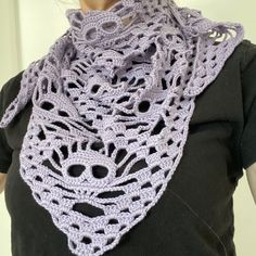 a woman wearing a purple crocheted scarf with holes in the middle and an openwork design