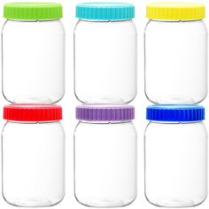 four glass jars with colorful lids are lined up