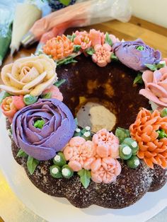 a cake decorated with flowers on top of a white plate