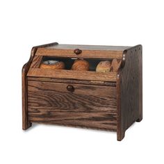 a wooden box filled with pastries on top of a white background and an open drawer