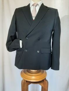 "Made by H & M  Romania of beautiful Italian wool,  this well cut double breasted jacket is  light weight, comfortable and elegant.  Two front tabbed pockets, two breast pockets plus ticket pocket. Excellent condition. Shoulder to shoulder 17\",  chest 38\",  sleeve 25\",  shoulder to hem 27\" and 40\" around the bottom." Fitted Double Breasted Long Sleeve Suit For Winter, Fitted Double Breasted Suit With Long Sleeves For Winter, Fitted Long Sleeve Sport Coat With Double-breasted Button, Fitted Long Sleeve Double-breasted Sport Coat, Fitted Outerwear With Lapel Collar And Double-breasted Buttons, Semi-formal Tuxedo Outerwear With Pockets, Fitted Double Breasted Suit With Pockets, Fitted Double-breasted Outerwear With Lapel Collar, Fitted Double Breasted Suit With Pockets For Formal Occasions