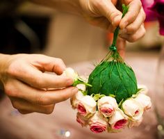 a person is holding flowers in their hands