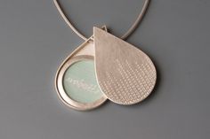 Beautiful and unique teardrop locket for one large photo. This handcrafted sterling silver locket holds your favorite picture or maybe an inspirational saying. The lid of this sterling silver locket is stamped with lines of little circles, that remind me of pearls of dew in the morning. Drop-Shaped-Locket for one picture -  26mm (1,02") wide, 40mm (1,57")long - thickness: ca. 4mm (0,15") - design: drops of dew - Sterling Silver How it works: * The lockets consist of two movable parts, fitting ti Silver Water Drop Earrings As Gift, Unique Locket Necklace, Unique Locket, Shape Pictures, Picture Locket, Sterling Silver Locket, Silver Picture Frames, Silver Locket, Jewelry Lockets