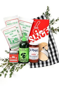 an assortment of food and condiments sitting on top of a cloth with green leaves