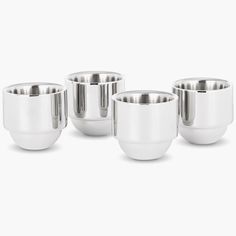 four stainless steel cups are lined up together