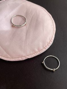 Simple unique classic by Camille Hempel.  Slim proportions but not at all dainty.  Can be made special order in any size, but the current sizes are 6 - 7.5.  Really cool ring for any and all genders and as a pinky ring.   This subtle hammered texture ring has two rose gold "rivets" on either side.  Rose gold is 10k and securely soldered in.  All edges are soft, ring is highly polished and very comfortable.  This ring is solid construction (but has Camille's signature Armor Ring look).  Lovely as a midi ring, pinky ring, on its own, or in a stack.  Stamped underneath with makers mark, sterling, 10k.  Comes in a lovely gift ring box. Modern Rose Gold Sterling Silver Ring, Hammered Sterling Silver Jewelry For Promise, Rose Gold Hammered Midi Rings, Dainty Hammered Rose Gold Rings, Everyday Hammered Rose Gold Rings, Adjustable Rose Gold Sterling Silver Midi Rings, Rose Gold Sterling Silver Midi Rings, Hammered Open Ring For Promise, Small Hoop Rose Gold Rings For Anniversary