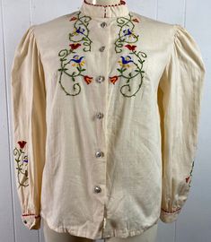 "Vintage 1970s cotton/linen bohemian hippy peasant blouse, shirt. Embroidered down each arm and front. Somewhat bloused sleeves and shoulders. Has metal button front. No label, but looks like an original store tag. About a size Large. Actual measurements are: 40\" at the bust 42\" at the waist 16\" shoulder seam to shoulder seam 22.5\" shoulder seam to cuff 23.5\" overall length In excellent unused condition, New Old Stock" Cotton Blouse With Embroidered Cuffs, Long Sleeve Cotton Blouse With Embroidered Cuffs, Fall Cotton Blouse With Embroidered Cuffs, Bohemian Cotton Blouse With Embroidered Cuffs, Summer Long Sleeve Blouse With Embroidered Cuffs, Long Sleeve Cotton Embroidered Top With Cuffs, Cotton Embroidered Cuff Long Sleeve Top, Cotton Embroidered Long Sleeve Top, Traditional Long Sleeve Blouse With Embroidered Cuffs