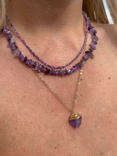 This set of three necklaces features beautiful amethyst crystals as its centerpiece. The amethysts are cut into different shapes and sizes, allowing each necklace to look unique and stunning on its own. The necklaces are made with delicate chains that allow the crystals to sit at the perfect length on the neck. With their rich, deep purple hue, amethysts are said to bring calmness and clarity to the mind, making this set of necklaces not only a beautiful accessory but a meaningful one as well. P Amethyst Necklace Aesthetic, Purple Accessories Aesthetic, Elegant Handmade Purple Crystal Necklace, Unique Purple Amethyst Necklace, Purple Amethyst Crystal Necklace In Mystical Style, Purple Faceted Amethyst Crystal Necklaces, Amethyst Crystal Necklace, Three Necklaces, Purple Accessories