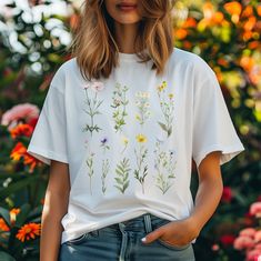 Hand-drawn unique watercolor floral graphic. True to size with a relaxed fit. Highly durable.  Comfortable unisex design. For an oversized look, choose one size up from your normal size. Made from 100% cotton, medium fabric (5.3 oz/yd² (180 g/m Features a professional high-quality print. Casual Watercolor Print T-shirt With Relaxed Fit, Summer Floral Embroidery Relaxed Fit T-shirt, Botanical Plants Print Relaxed Fit T-shirt, White Casual T-shirt With Plant Print, Cottagecore Printed T-shirt With Relaxed Fit, Casual White T-shirt With Plant Print, White Floral Print Relaxed Fit Shirt, Cotton Botanical T-shirt For Spring, Cottagecore Printed Crew Neck T-shirt