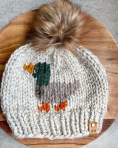 a white knitted hat with ducks on it