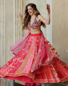 a woman in a red and pink dress dancing