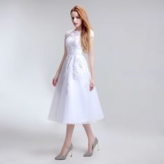 a woman wearing a white dress and high heels