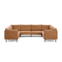 a tan leather sectional sofa with two ottomans on the bottom and one arm facing it