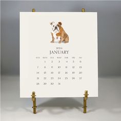 a calendar with an image of a dog sitting on it's side, in front of a gray background