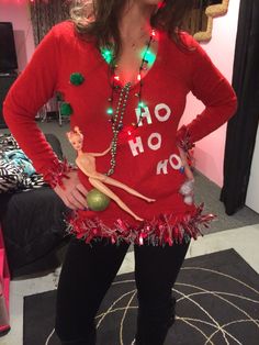 a woman in a red sweater with christmas lights on her shirt and leggings