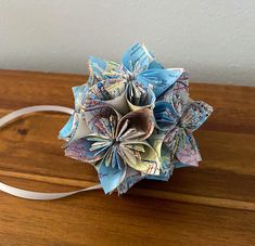 an origami flower on a wooden table