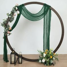 a wedding arch decorated with flowers and greenery