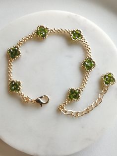 Meet our Handmade Four-Leaf Clover Bracelet - a symbol of luck and style.  Created with 3mm faceted beads and galvanized gold Miyuki seeds, this bracelet adds a touch of charm to your everyday look. Adjustable from 6.5 to 8.5 inches, it ensures a comfortable fit.                          Want a custom fit? Leave a message for your preferred length and enjoy the simplicity of personalized beauty. Lucky vibes, effortless style - that's our Four-Leaf Clover Bracelet. This product features a lobster clasp for the adjustable version, with a length of 6.5-8.5 inches, and a magnetic clasp for the fixed version, with selectable lengths.  Note that thread may be visible as it is handmade. Please note that there may be slight color differences between the images and the actual product. Beaded Clover Bracelet, Beaded Leaf Bracelet, Clover Leaf Jewelry, Symbol Of Luck, Clover Bracelet, Miyuki Bracelet, Beaded Leaf, Beaded Bracelets Tutorial, Beading Jewelery