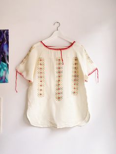 PLEASE NOTE new orders will be shipped after 13th of March due to holiday 💝 please enjoy 15% off the whole collection 💕   Vintage cotton folklore top with embroidery. From the seventies. Lovely embroidery with green and red threads. Cute details. In a used condition, some little signs but nothing major. Fits for size L or XL, but please check measurements to be sure. size L / XL armpit to armpit: 55cm length: 70cm Please compare it with a garment you already own to be sure :) Thank you for visiting my shop <3  { Please read this before shopping } -  Please note that you are buying a vintage garment, garments will not be as new but I check each item very well. Major flaws are always noted in description. Everything is steamed before shipping - All sales are final  - Within Europe I ship m White Folk Peasant Top For Festival, Bohemian Spring Blouse With Motif, Bohemian Spring Top With Motif, Bohemian Tops With Motif For Spring, White Peasant Top For Festival, Bohemian Motif Tops For Spring, Spring Bohemian Blouse With Motif, Festive Cotton Tops With Embroidered Border, Bohemian Blouse With Motif For Spring