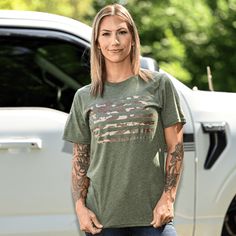 WOMEN'S BOYFRIEND FIT ARMY GREEN CAMO AMERICAN PATRIOTIC T-SHIRT 🇺🇸 Knit, Dyed, Cut & Sewn in America Our best-selling camo American flag design is now available in a new Army green color! The Women's Camo American Flag Patriotic Boyfriend Fit T-Shirt is the perfect blend of classic Americana and OCP-style camo. Screen printed on a lightweight, ultra-soft poly/cotton shirt in heather Army green BOYFRIEND FIT - Longer length, roomier sleeves, unisex fit. The model is 5'4" and 120 pounds and is 120 Pounds, American Flag Design, Army Green Color, Classic Americana, Womens Camo, Heather Green, American Patriot, Flag Design, Green Camo