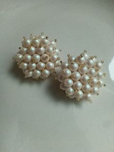 These earrings are large, slightly larger than a quarter. Glass pearls are clustered together for an elegant and timeless look. the pearlescent coating gives the look of a classic pearl with a slighly pinkish hue  Gold-plated post and a leather backing is used for comfort and a monster ear-nut is used for support. White Beaded Pearl Earrings, White Pearl Cluster Earrings With Pearl Drop, Pearl Earrings For Evening, White Round Bead Pearl Earrings For Formal Occasions, White Pearl Clip-on Earrings With Pearl Charm, Formal White Pearl Round Bead Earrings, White Pearl Charm Bridal Earrings For Evening, Formal White Cluster Earrings With Pearl Drop, White Bridal Earrings With Pearl Charm For Evening