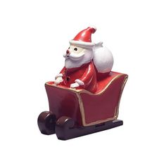 a santa clause figurine sitting on top of a red sleigh