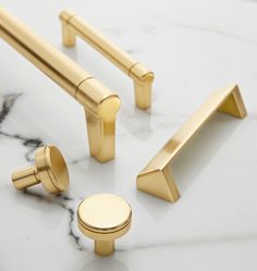 brass handles and knobs on a marble countertop