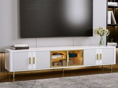 an entertainment center with a large flat screen tv mounted on it's side wall