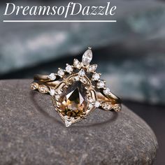 a diamond ring sitting on top of a rock with the words dreams of pazzle above it