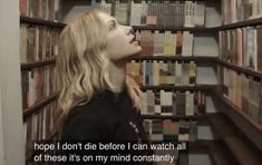 a woman standing in front of a bookshelf with her head tilted to the side