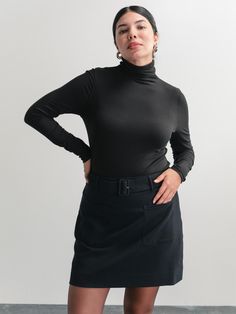 A turtleneck is a staple piece for a classic look, worn by itself or under any sweater or jacket. This one has interesting details such as a fine ribbed fabric and buttons up the back of the neck—yes, wear your hair up to show them! And remember, the little details of your life matter. Fall Everyday Turtleneck Tops, Long Sleeve Turtleneck For Fall, Fall Long Sleeve Turtleneck For Everyday, Black Turtleneck For Fall Workwear, Long Sleeve Turtleneck For Everyday Fall Wear, Black Turtleneck For Workwear In Fall, Classic Mock Neck Top For Layering, Elegant Stretch Mock Neck Top For Fall, Versatile Long Sleeve Mock Neck Top